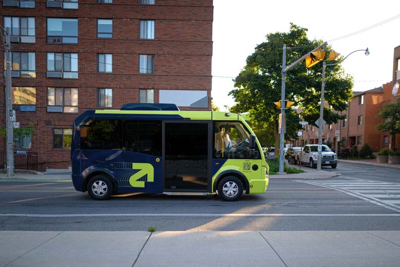 image of the agro bus against a building