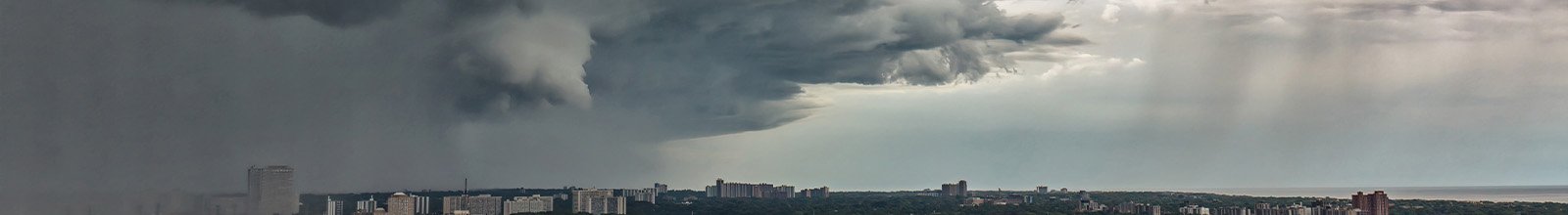Clouds with Funnel cloud formation and downpour over east Toronto in summer sky