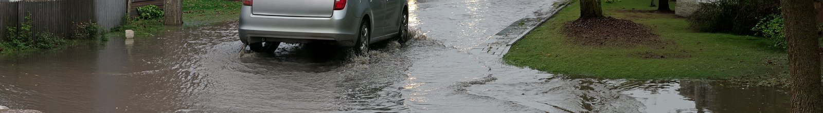 Car driving through flooded street