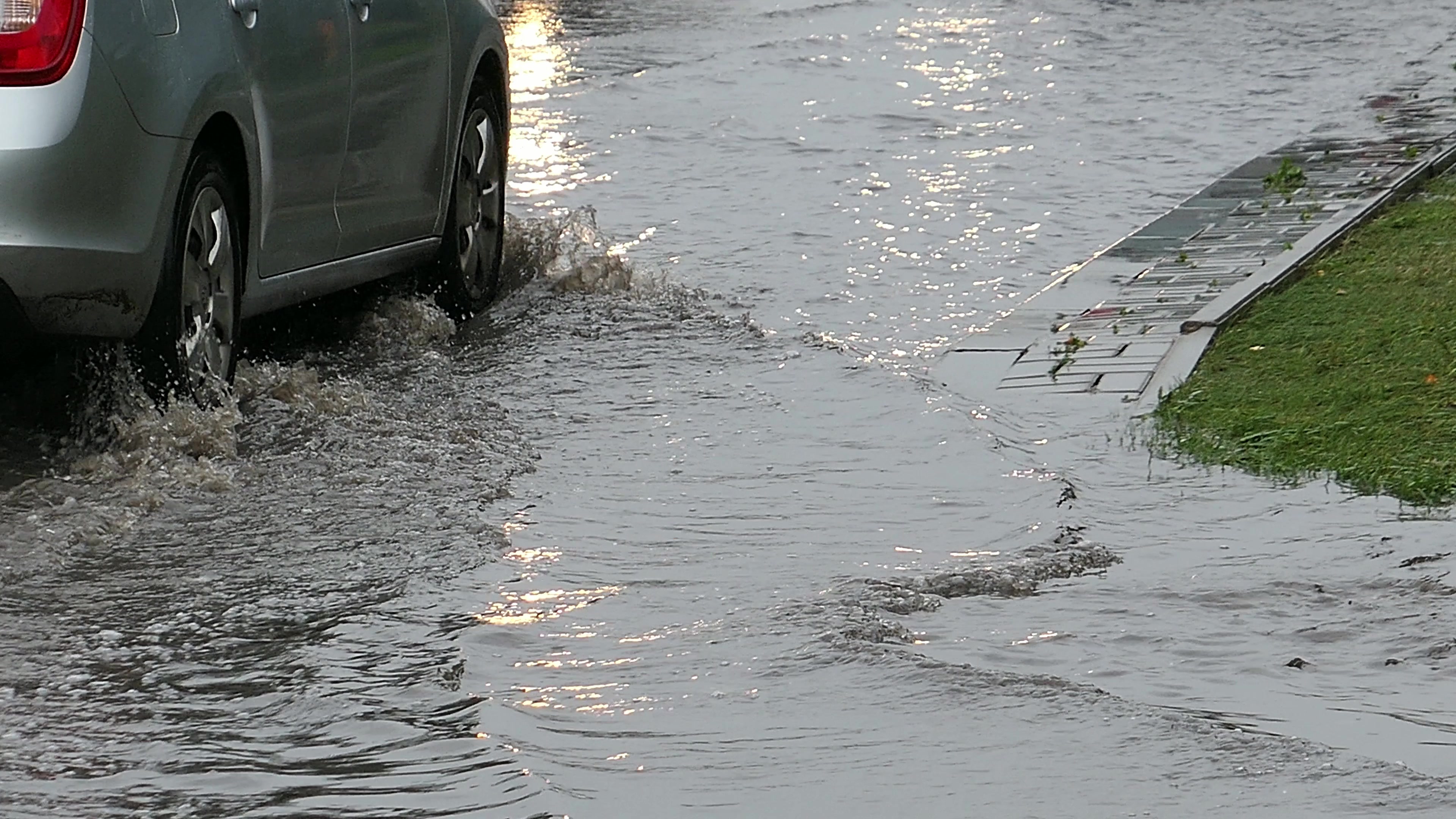 Car driving through flooded street