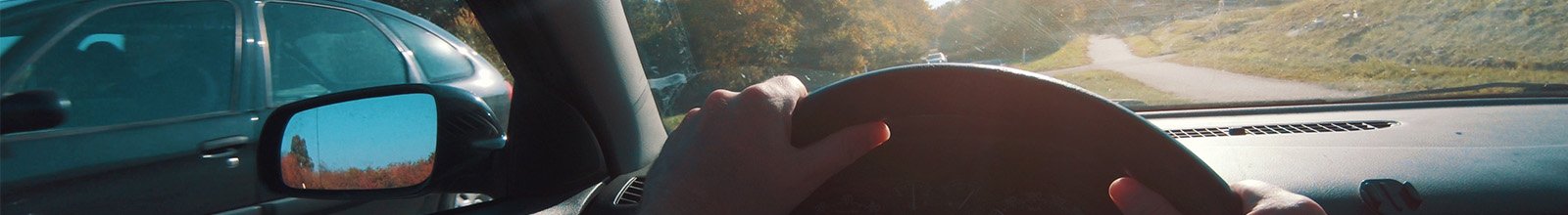 driver in car with view of steering wheel