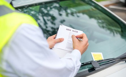 Photo of enforcement officer issuing a parking ticket