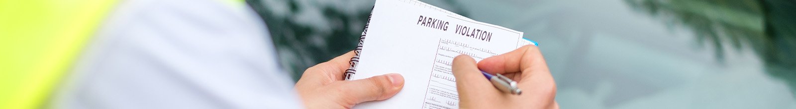 Photo of enforcement officer issuing a parking ticket