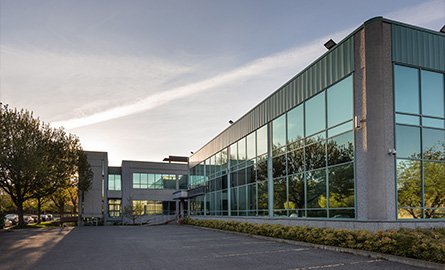 Photo of office building exterior and parking lot