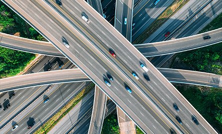 Image of highways intersecting with cars on it