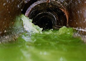 View from inside of a drain pipe with green dye