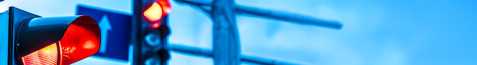 Red light camera sign with blue background