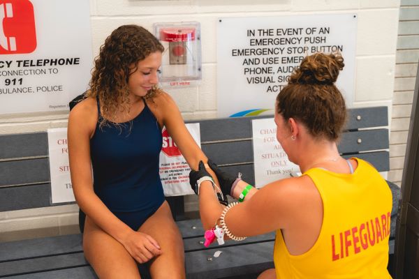 lifeguard performing first aid
