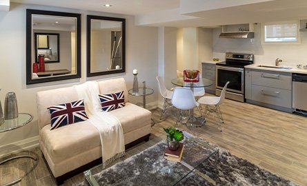  Interior of modern urban residence in basement of the family home, with dinning room, common area and the view of the kitchen.