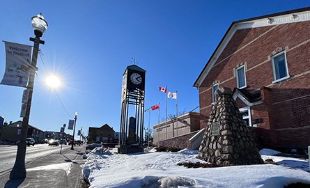 Exterior view of BWG's Finance building and the court house courtyard and clock tower on Holland Street East