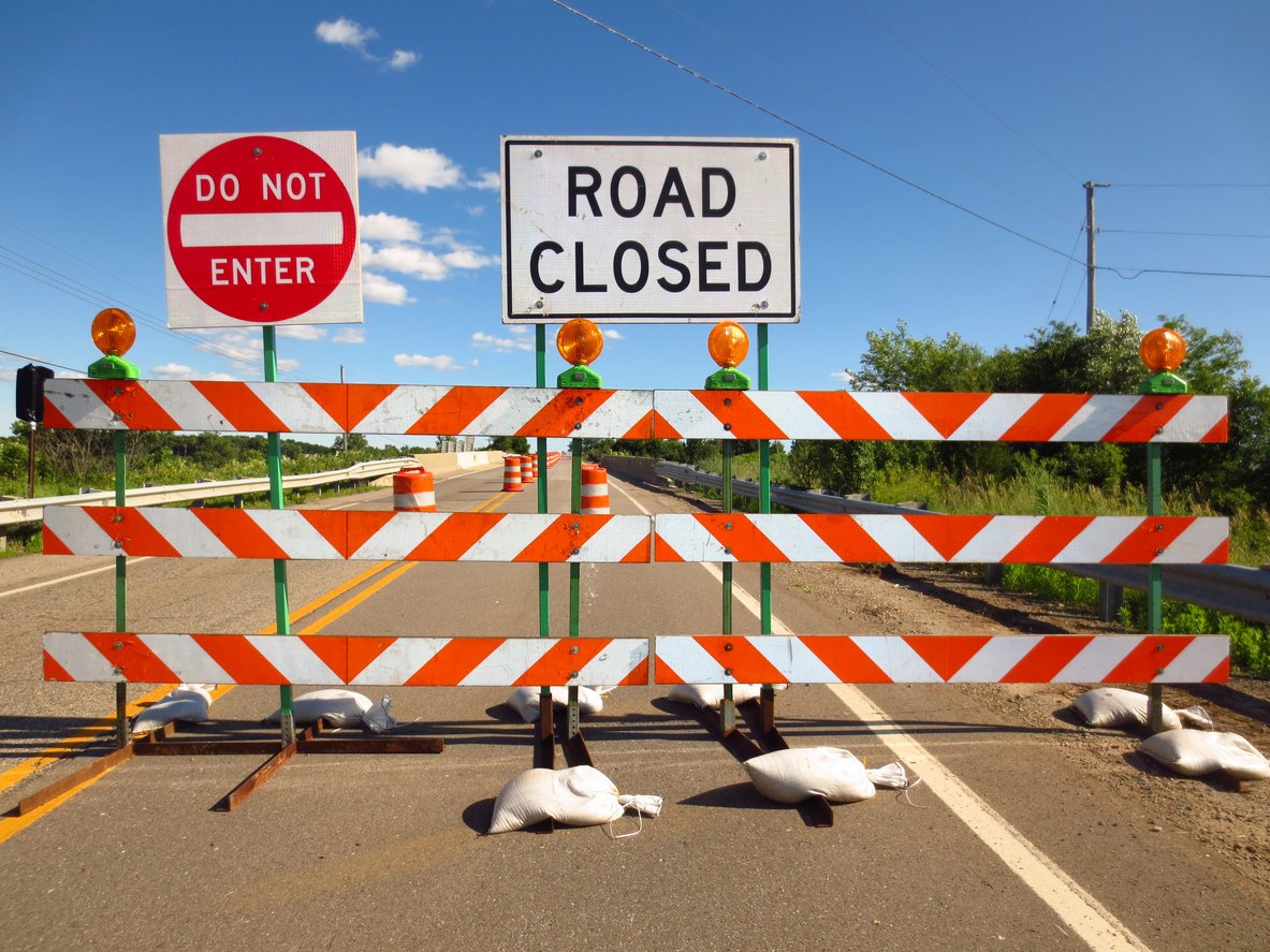 Image of closed road with barriers and road closed sign