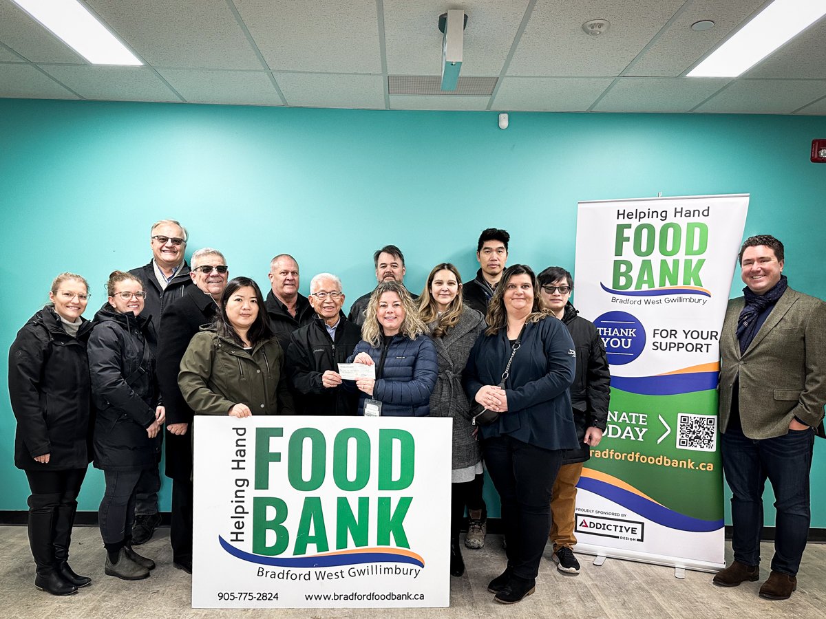 BWG Building Division, and Council members presenting a cheque to the Bradford Helping Food Bank employees