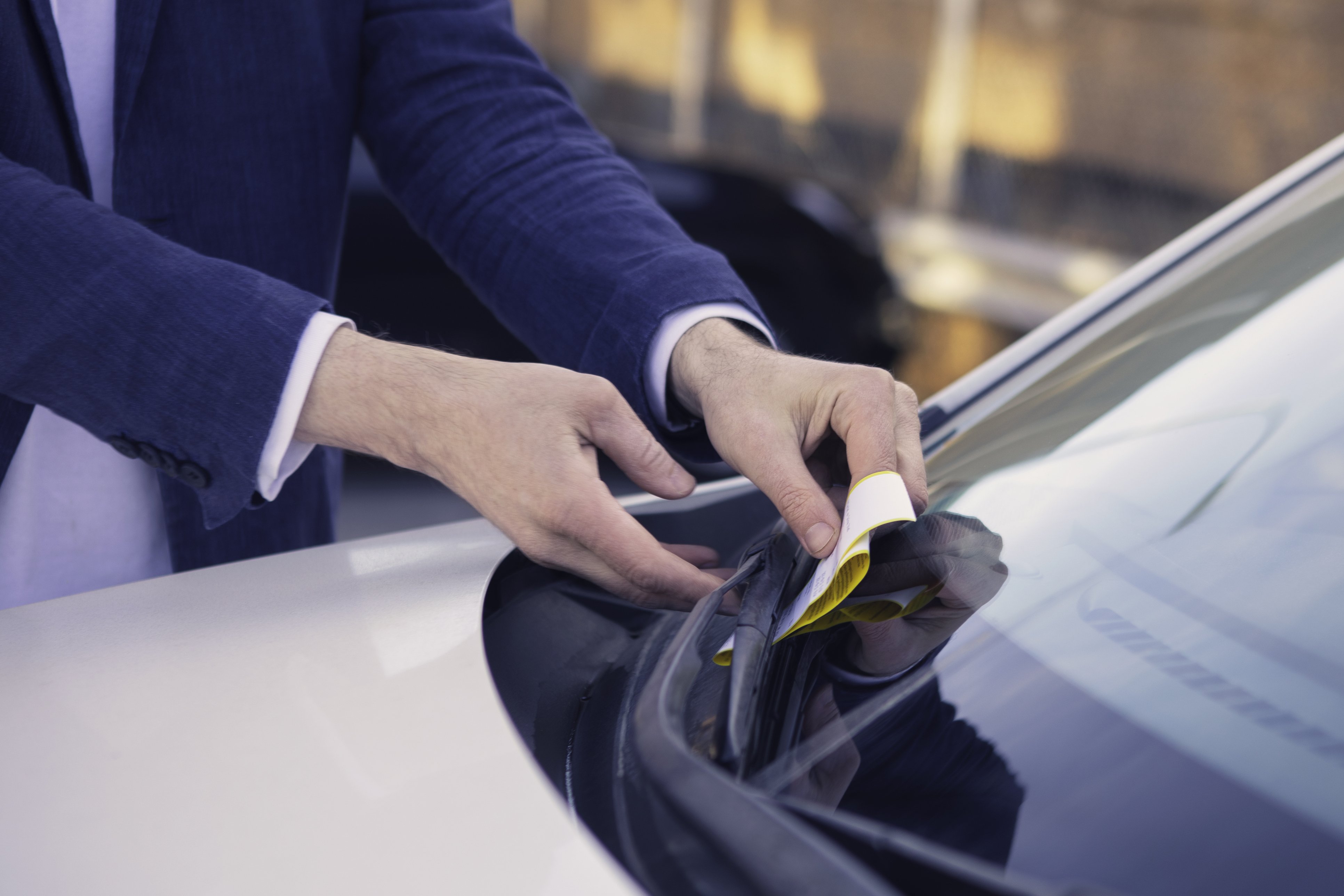 image of a parking ticket on a car windshield