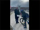 Mayor Leduc giving out prize to bike rider at school