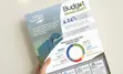Hand holding the Budget 2024 highlights flyer