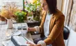 Businesswoman sitting at a coffee shop using a tablet 