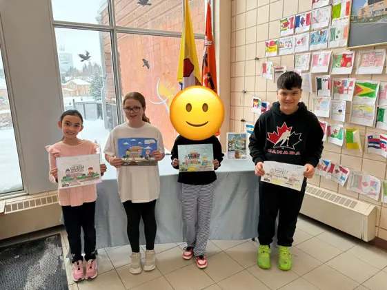 colouring contest winners holding their photos for displayr