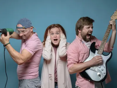 Man with drill, Woman with hands over ears, man with guitar