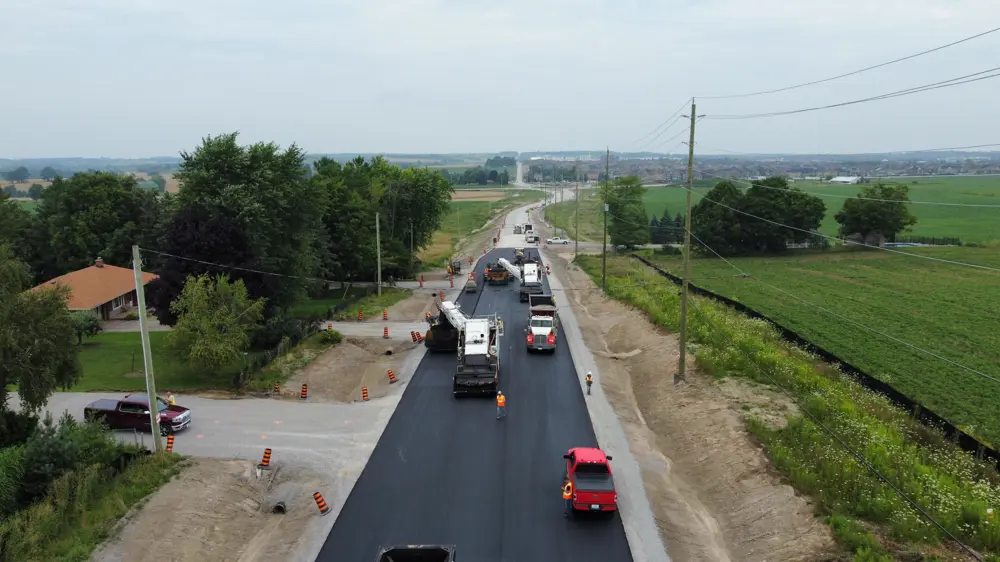 August 2023: Paving operations on Sideroad 10 looking north towards the new roundabout.