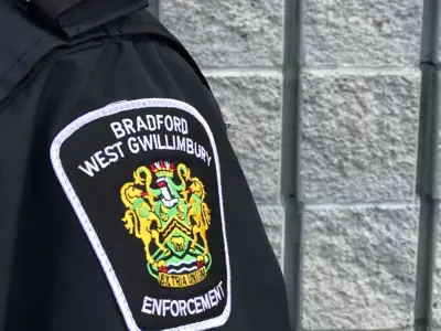 Shoulder with enforcement crest, brick wall in the background