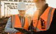 Engineers reviewing information on their tablet at a construction site