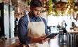 Small business owner reading his tablet