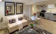  Interior of modern urban residence in basement of the family home, with dinning room, common area and the view of the kitchen.