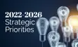 Background photo of lightbulbs with gears inside, one bulb is lit. Overlay text reading "2022-2026 Strategic Priorities"