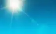 Blue summer sky with bright sun shining